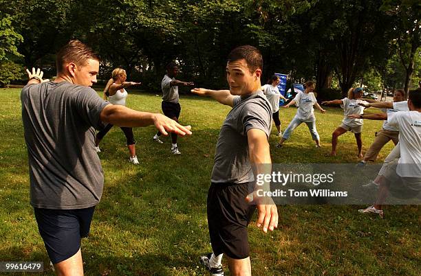Chris Banks, left, Navy liaison, and Joshua Cambra, intern for Sen. Patty Murray, take part in a stretching seminar at the 2nd annual WalkingWorks...