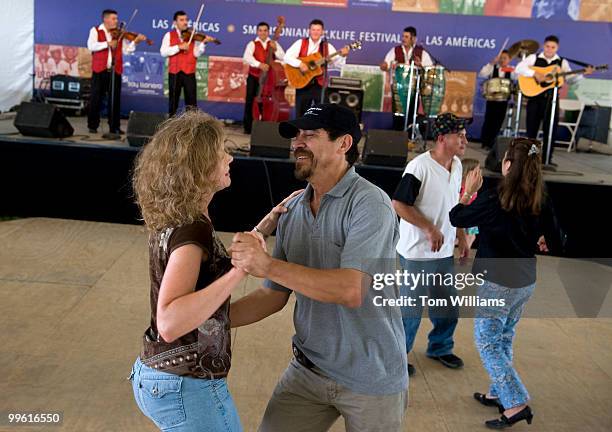 Arnaldo Borja of Mexico, dances with Beth Romero of Arlington, in the Las Americas section of the Smithsonian Folklife Festival, July 1, 2009.