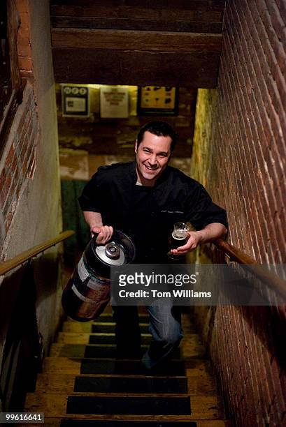 Teddy Folkman, executive chef at Granville Moore's on H St. NE, poses for a picture with a keg and a glass of beer, April 14, 2009.
