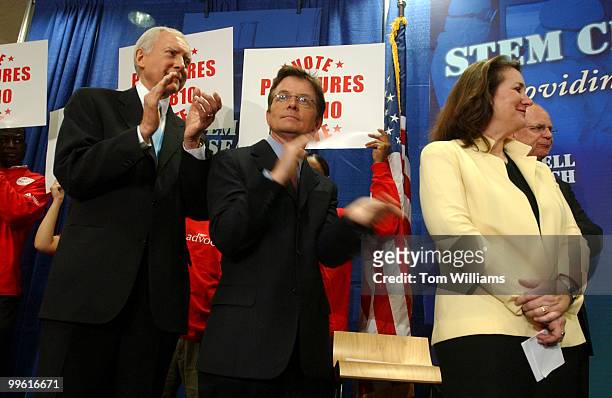 From left, Sen. Orrin Hatch, R-Utah, actor Michael J. Fox, Reps. Diana DeGette, D-Colo., and Mike Castle, R-Del., applaud during a news conference...