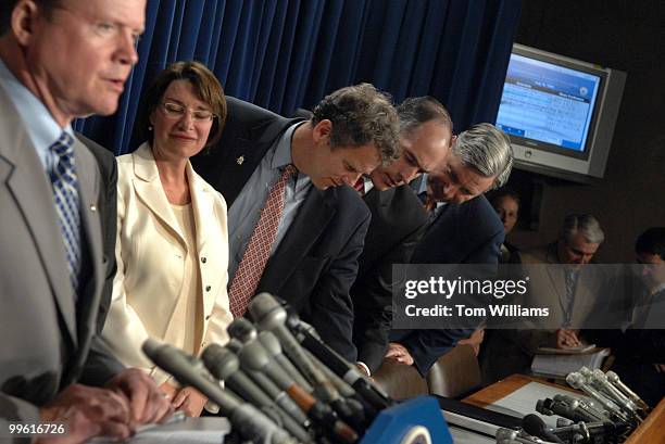 Sens. Sherrod Brown, D-Ohio, left, Bob Casey, D-Pa., center, and Sheldon Whitehouse, D-R.I., go over notes while Sen. Jim Webb, D-Va. Speaks at the...