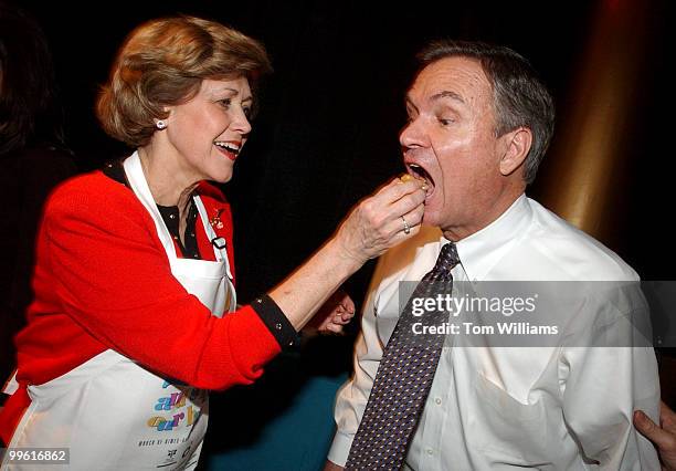 Lois Breaux feeds hers husband Sen. John Breaux, D-La., Crawfish la Louisiane, which won the award for best regional cuisine, at the March of Dimes...