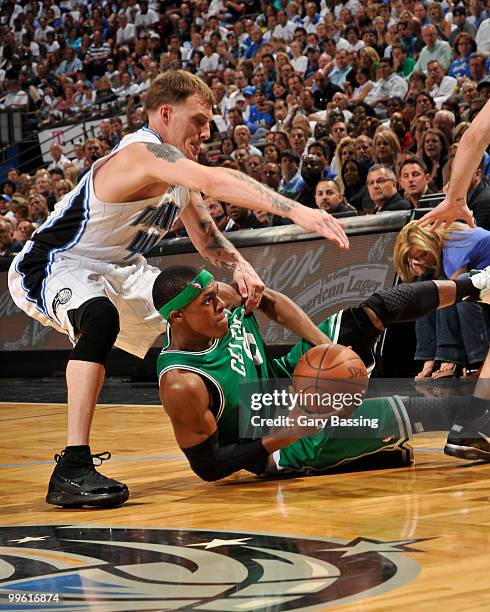 Rajon Rondo of the Boston Celtics fights for a loose ball against Jason Williams of the Orlando Magic in Game One of the Eastern Conference Finals...