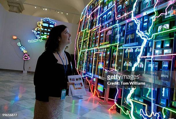 Intern Caroline Barker views a neon map of America by Nam June Paik, in the Smithsonian American Art Museum and National Portrait Gallery. The two...