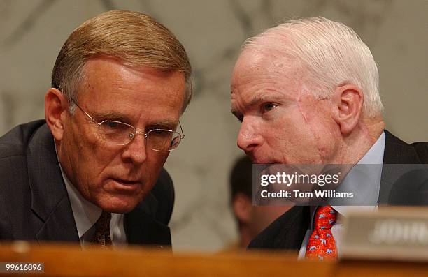 Sen. Byron Dorgan, D-N.D., and Sen. John McCain, R-Ariz., have a word during an oversight hearing to investigate "Lobbying Practices Involving Indian...