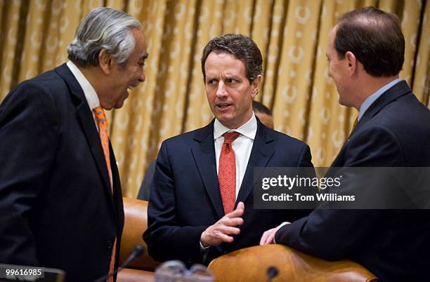 Secretary of the Treasury Tim Geithner, center, talks with Chairman Charlie Rangel, D-N.Y., left, and ranking member Dave Camp, R-Mich., before a...