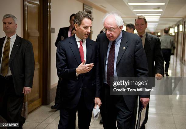 Secretary of the Treasury Tim Geithner, left, talks with Sen. Bernie Sanders, I-Vt., en route to a Senate Budget Committee hearing where Geithner...