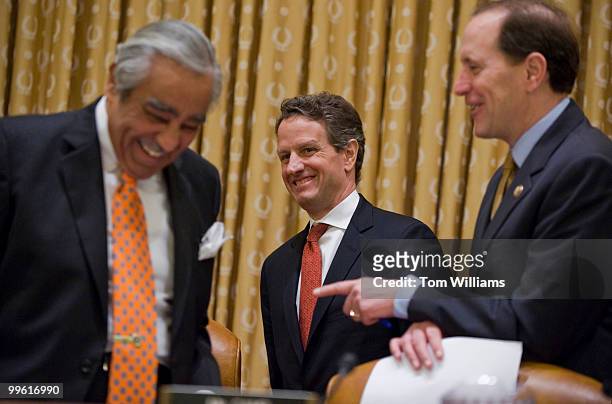 Secretary of the Treasury Tim Geithner, center, talks with Chairman Charlie Rangel, D-N.Y., left, and ranking member Dave Camp, R-Mich., before a...