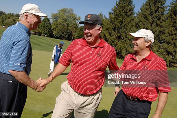 Rep. Albio Sires, D-N.J., is congratulated by Rep. Buck McKeon, R-Calif., and Chet Edwards, D-Texas, for sinking a an usual putt at the First Tee...