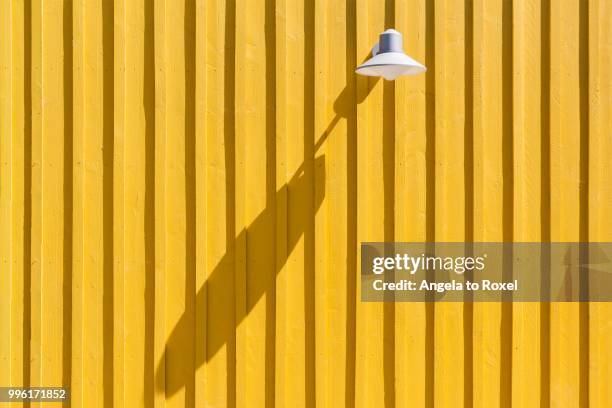 lamp on a yellow beach hut casting a long shadow, ile d'oleron, charente maritime, poitou-charentes, france - charente bildbanksfoton och bilder