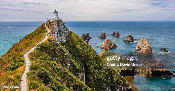 nugget point lighthouse, otago, nz - nugget point stock pictures, royalty-free photos & images