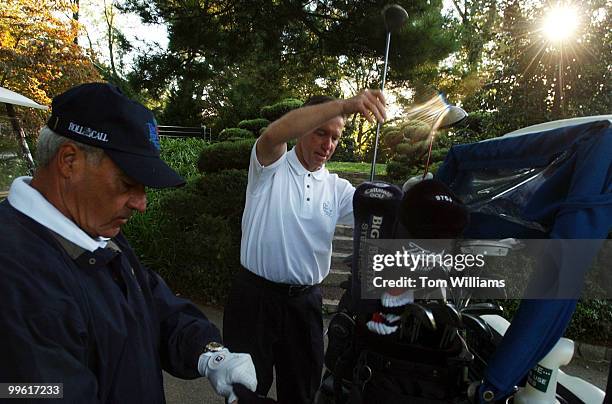 Reps. Joe Baca, D-Calif., left, and Steve Lynch, D-Mass., gets clubs out of their bags at the First Tee Congressional Golf Tournament held at...