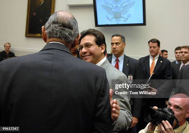 Attorney General Alberto Gonzales talks with Chairman of the House Judiciary Committee John Conyers, D-Mich., before a hearing on the U.S. Attorney...