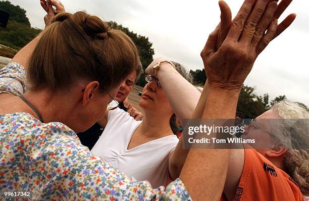 Jacquline, who declined to give her last name, from Indiana, participates in the laying of hands, at a spiritual rally held by the Maryland/D.C...