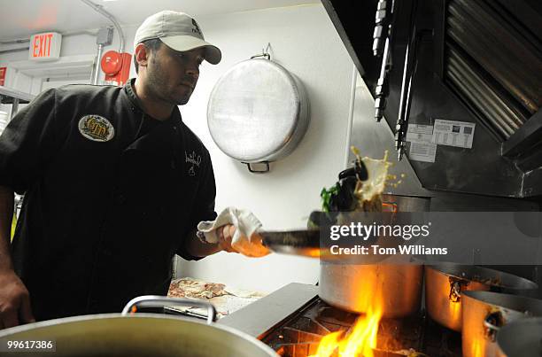 Teddy Folkman, executive chef/owner of Granville Moore's, prepares a serving of Moules Fromage Bleu, which are mussels with bacon and bleu cheese, at...