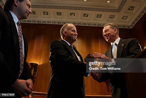 Sen. Chuck Grassley, R-Iowa, presents awards to John W. Schilling, left, and James Anderson, center, for acting as whistleblowers on a vast network...