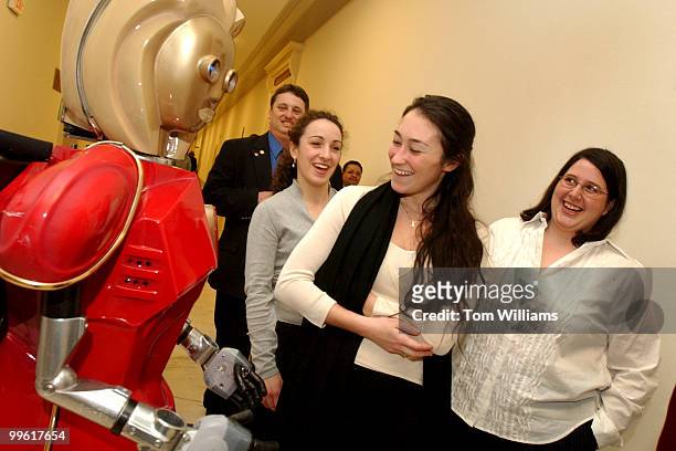 Dana Dupree from the office of Rep. Billy Tauzin, R-La., shares a laugh with Holly Heart, a robot on hand to promote the "National Woman's Heart...