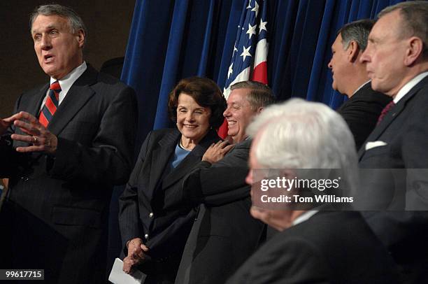 Sens. Dianne Feinstein, D-Calif., and Lindsey Graham, R-S.C., share a laugh at a news conference to discuss the immigration bill. Also attending are,...