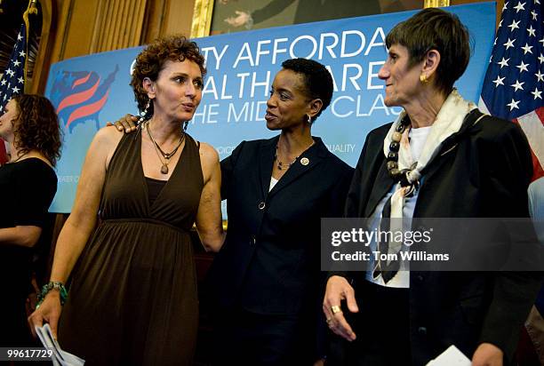 Uterine cancer survivor Molly Secours, left, is congratulated by Reps. Donna Edwards and Rose DeLauro, D-Conn., for sharing her story at a news...