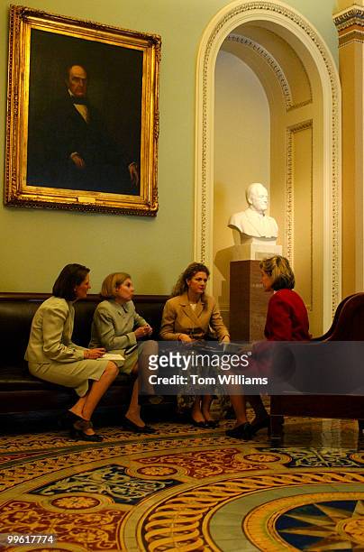 Sen. Kay Bailey Hutchison, R-Texas, confers with staff members in between votes during the "vote-a-rama."