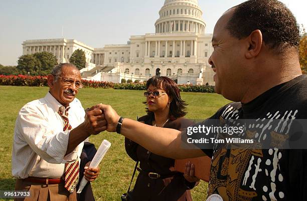 Pastor Ed Bell of Detroit, right, greets Rep. John Conyers, D-Mich., after the Congressman spoke at a rally on the West Front to supoort legislation...