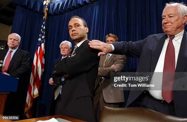 Rep. Luis Gutierrez, D-Ill., gets a pat on the arm from Rep. Jim Kolbe, R-Ariz., as from left, Sens. John McCain, R-Ariz., Ted Kennedy, D-Mass., and...