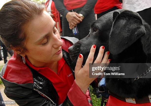 Nicole Pedone of Cleveland, has a word with her guide dog Lorenzo before a news conference to oppose S.1995, the "Health Insurance Marketplace...