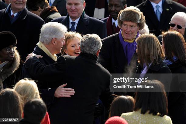 Former President George W. Bush greets former President Bill Clinton, Secretary of State nominee Hillary Clinton and former President George H.W....