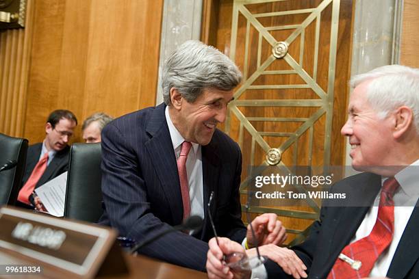 Sen. John Kerry, D-Mass., talks with Sen. Richard Lugar, R-Ind., before former national security advisers Zbigniew Brzezinski and Brent Scowcroft...