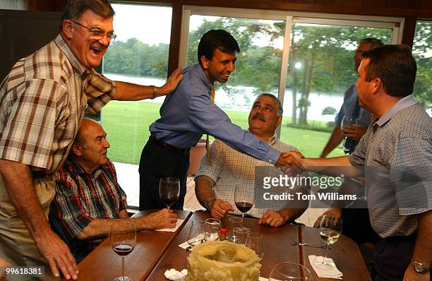 Rep. Bobby Jindal, R-La., 1st District, greets Joe Sanford, right, Ray Autry, left, and Matt Ackel, center, during a meeting of the local chapter of...