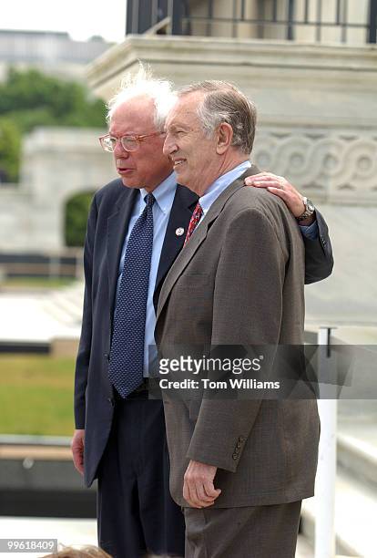 Rep. Bernie Sanders, I-Vt., left, and Sen. Jim Jeffords, I-Vt., pose for a picture with school kids on the Senate Steps.