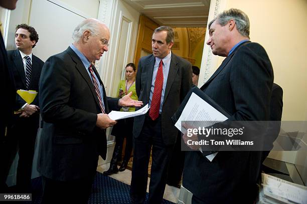 From left, Sens. Ben Cardin, D-Md., Jeff Merkley, D-Ore., and Sheldon Whitehouse, D-R.I., confer before a news conference on job creation, Feb. 22,...