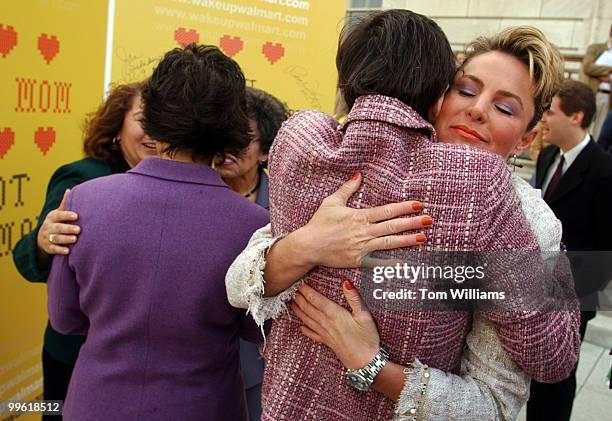 Former Miss America Carolyn Sapp, hugs Rep. Rosa DeLauro, D-Conn., after signing the "Mother of All Mother's Day" card, calling on Wal-Mart CEO, Lee...