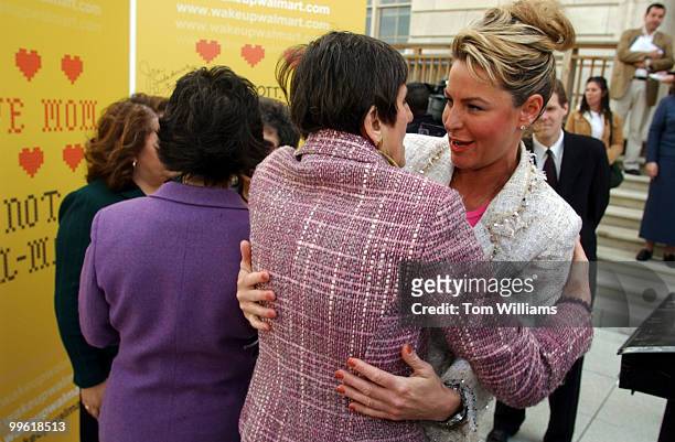 Former Miss America Carolyn Sapp, hugs Rep. Rosa DeLauro, D-Conn., after signing the "Mother of All Mother's Day" card, calling on Wal-Mart CEO, Lee...