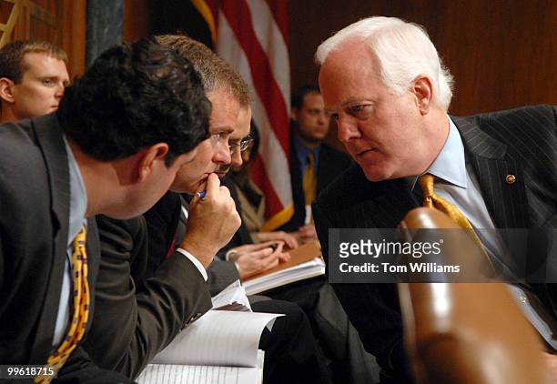 Sen. John Cornyn, R-Texas, confers with staff during a Senate Judiciary Committee hearing on proposals to limit Guantanamo detainees' access to...