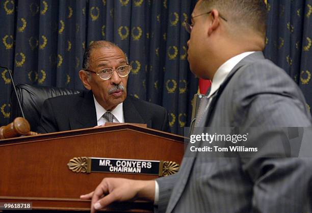 House Judiciary Committee Chairman John Conyers, D-Mich., left, talks with Rep. Keith Ellison, D-Minn., before a meeting to consider a resolution...