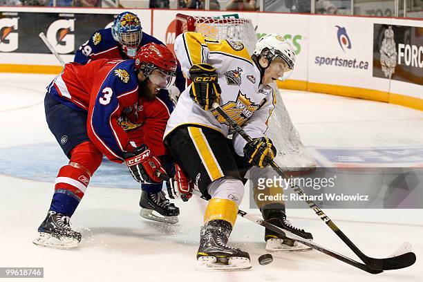 Matt Calvert of the Brandon Wheat Kings loses control of the puck while being defended by Brandon Gormley of the Moncton Wildcats during the 2010...