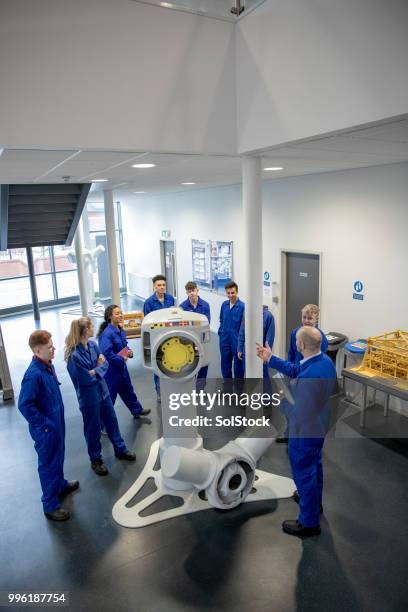 teaching the class on renewable energy - windmill girls stock pictures, royalty-free photos & images