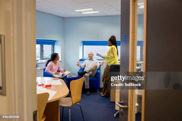 engineering tutors hold a meeting in the staff room - staffroom stock pictures, royalty-free photos & images