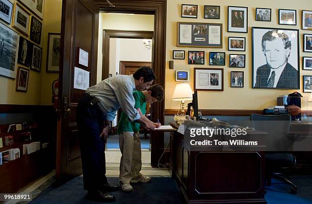 Andy Litsky of D.C. And his nephew Robert Litsky of New York City, sign a condolence book in the Russell office of Sen. Ted Kennedy, D-Mass., who...