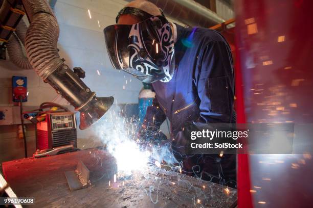welding in the engineering workshop - automatic welding torch stock pictures, royalty-free photos & images