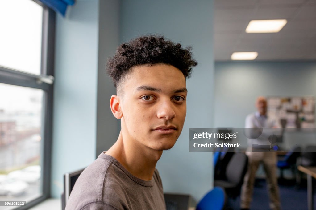 Teenage Boy Sitting in Class