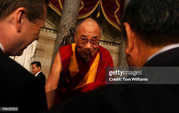 The Dalai Lama bows to guests after a ceremony celebrating the 20th Anniversary of the Human Rights Caucus. Reps. Frank Wolf, R-Va., and Tom Lantos,...