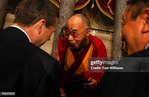 The Dalai Lama bows to guests after a ceremony celebrating the 20th Anniversary of the Human Rights Caucus. Reps. Frank Wolf, R-Va., and Tom Lantos,...