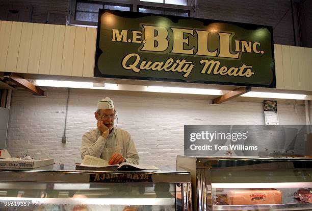 Butcher reads the paper at Central Market, the country's oldest farmer's market started in 1730, in Lancaster, Pa. About 30 ambassadors, embassy...