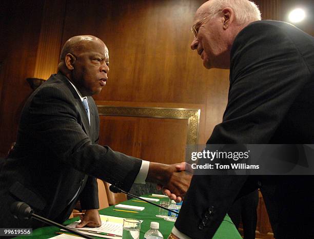 Rep. John Lewis, D-Ga., talks with Sen. Pat Leahy, D-Vt., before a Senate Judiciary Committee hearing on the 50th anniversary of the Civil Rights Act...