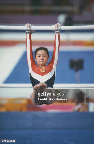 Zhou Ping of China competes in the women's uneven bars competition of the artistic gymnastics events at the 1984 Summer Olympics in Los Angeles in...