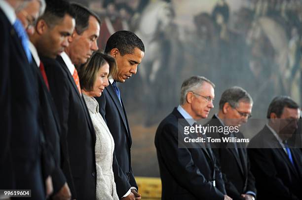 President Barack Obama, fourth from right, bows his head for the invocation for a ceremony honoring the 200th birthday of Abraham Lincoln, February...