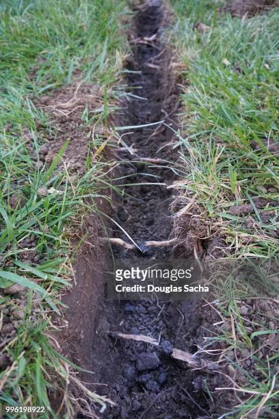 open cut type trench in the grass area - hacke stock-fotos und bilder