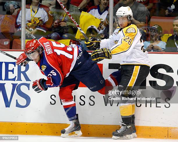 Darren Bestland of the Brandon Wheat Kings body checks Marek Hrivik of the Moncton Wildcats during the 2010 Mastercard Memorial Cup Tournament at the...